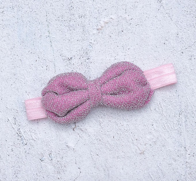 Blythe pink elasticized headband  with decorative bow