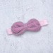 Blythe pink elasticized headband  with decorative bow