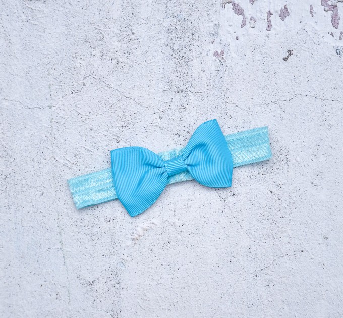 Blythe blue elasticized headband  with decorative bow